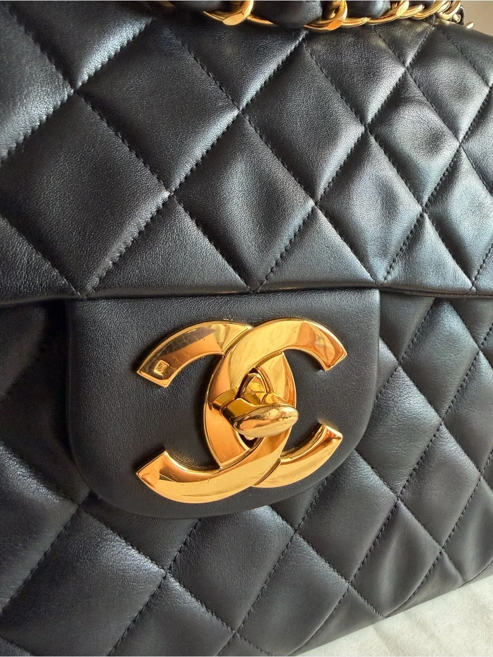 CHANEL Black Quilted Shoulder Bag with Gold Chain & CC Lock